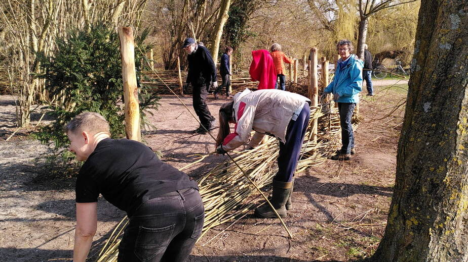 Vrijwilligers werken aan de omheining Vrijwilligers werken aan de omheining